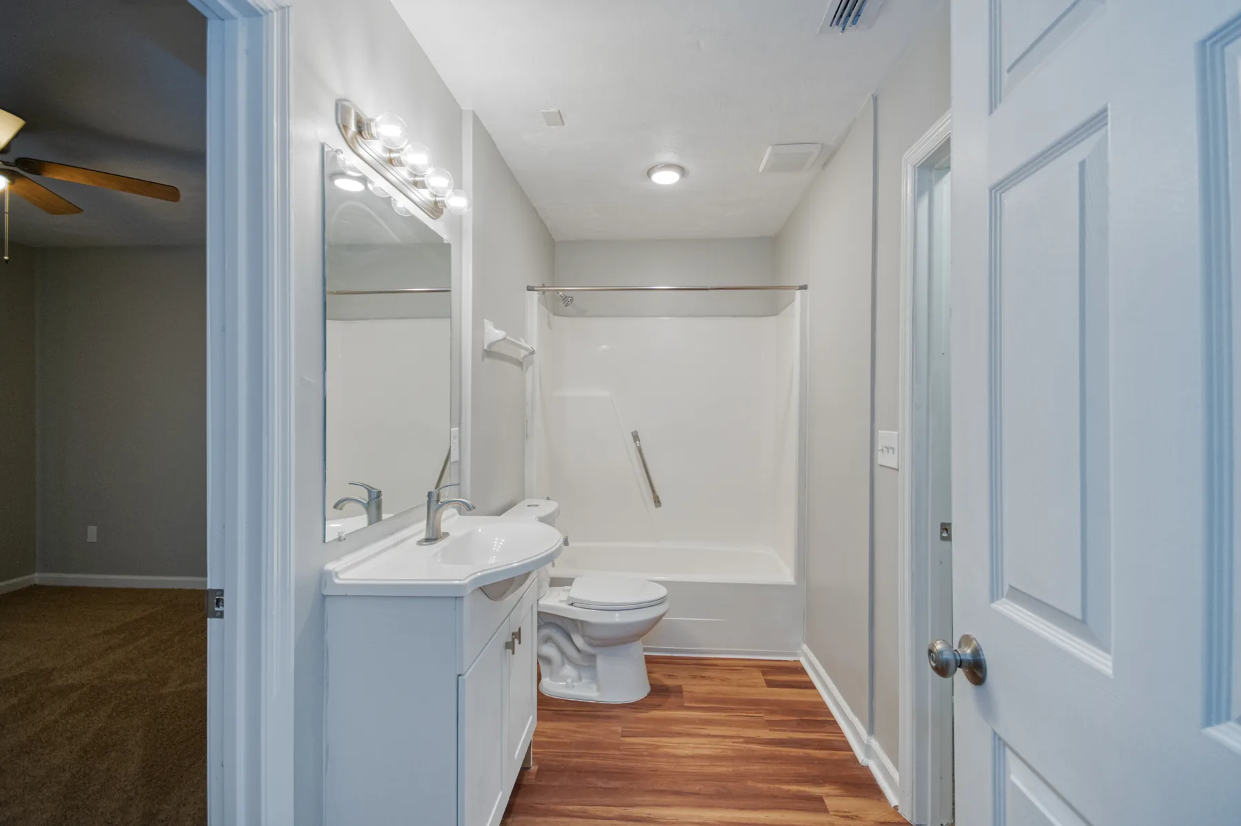 Full bathroom with tub shower and vanity at Castle Apartments