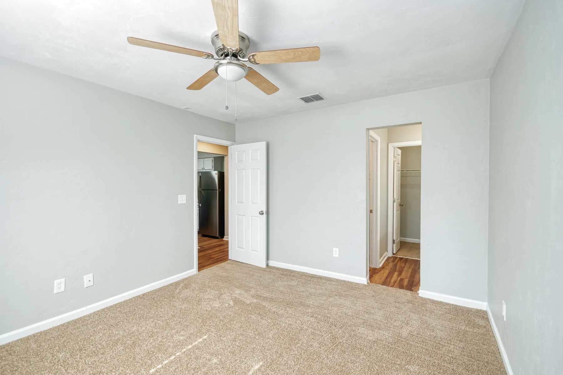 Bedroom with ceiling fan, closet and bathroom access at Castle Apartments